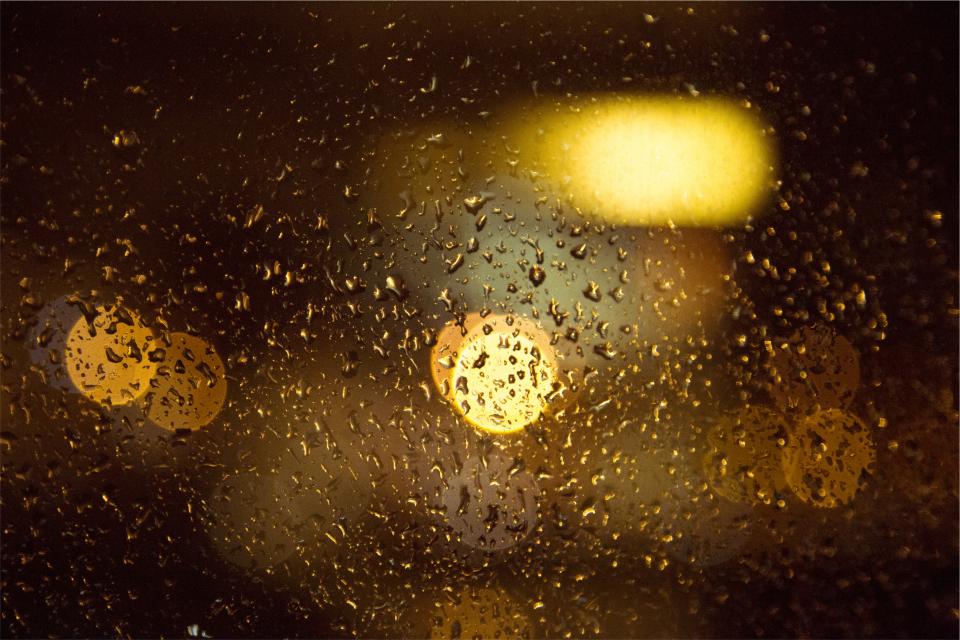 window raining raindrops night lights blurry 