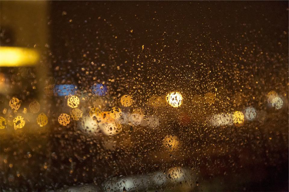 window raining raindrops night lights blurry 