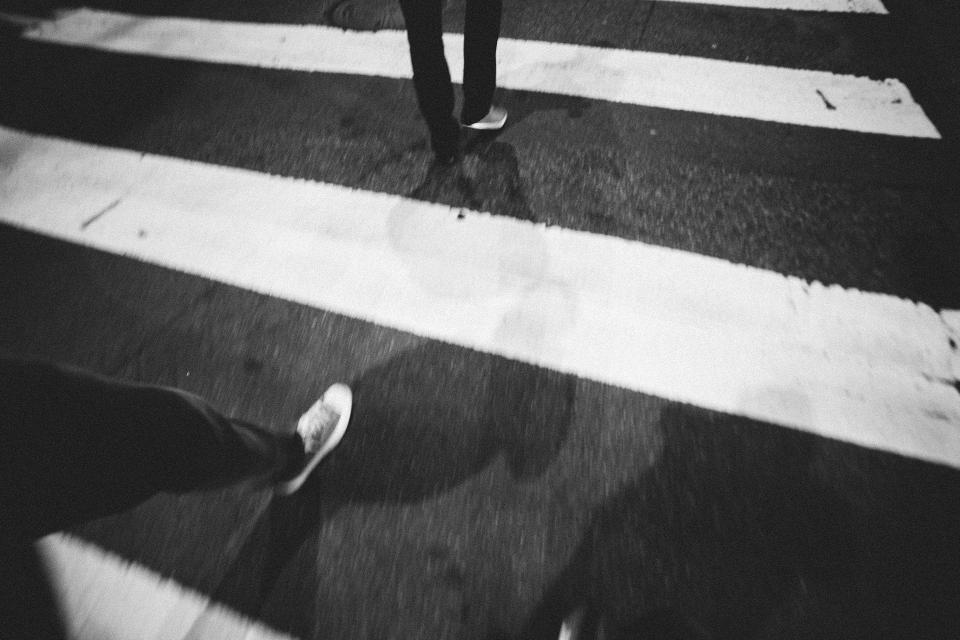 street shoes shadows pavement night evening crosswalk 