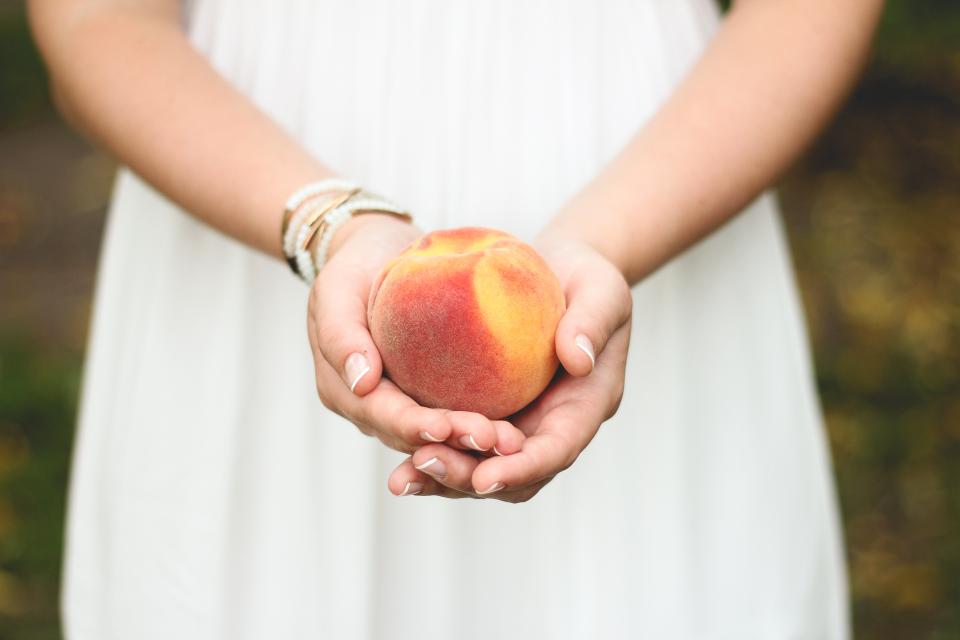 peach hands fruit 