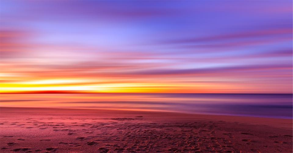 water sunset sky shore sea sand purple ocean horizon footprints beach 