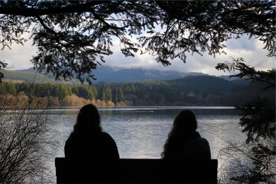 water trees sitting shadow people outdoors nature mountains landscape lake girls bench 