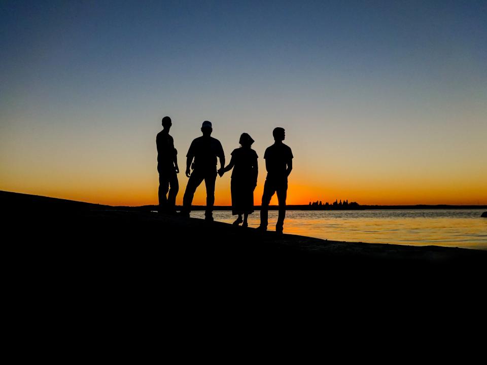 woman water vacation travel sunset silhouette reflection people men lake island horizon group friends family evening dusk canada 