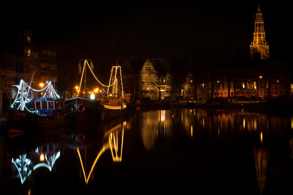 water town reflection night Netherlands lights houses Groningen evening dark city canal boats 