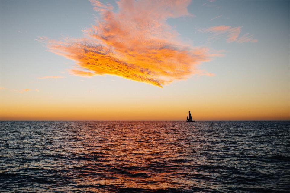 water sunset sky sea sailboat ocean dusk clouds 