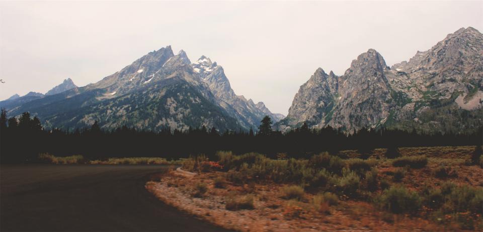 rural road peaks mountains landscape fields 