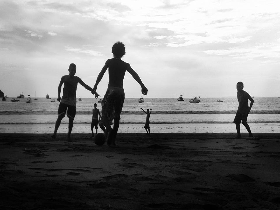 water soccer shore sea sand playing ocean kids children boats blackandwhite beach ball 
