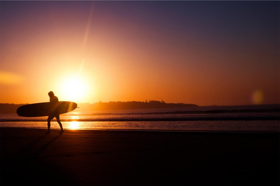 surfer surfboard sunset sky sea sand ocean dusk beach 