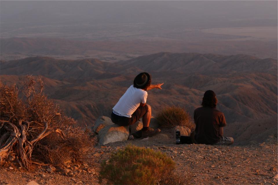 pointing people hills desert 