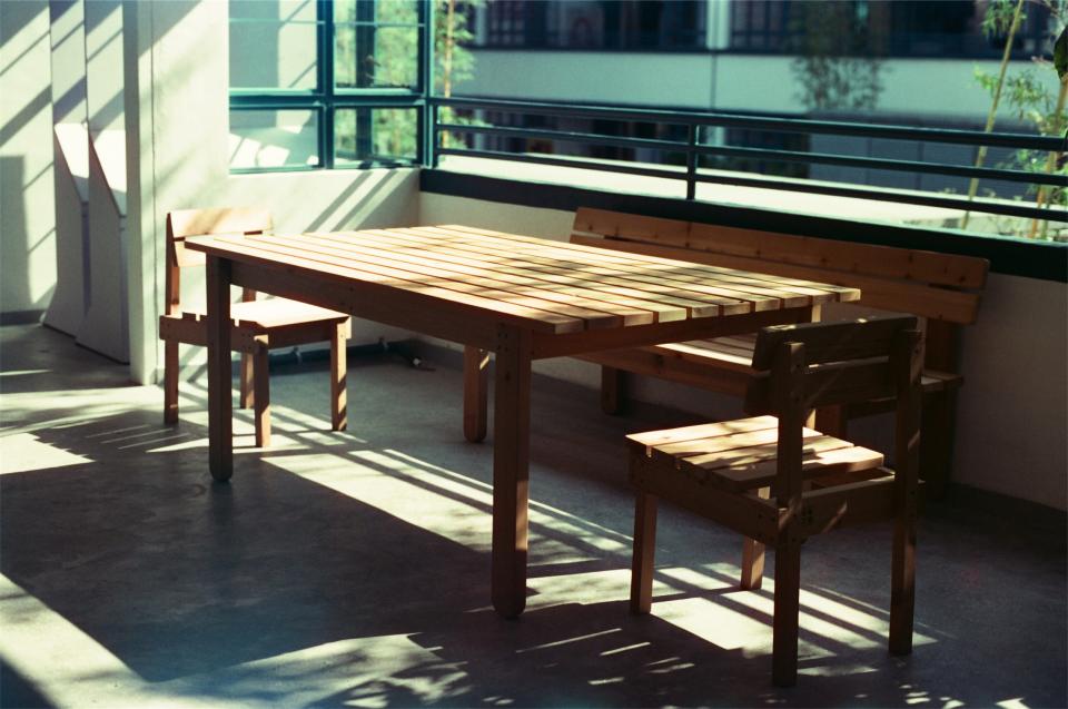 wood table sunlight chairs bench balcony 