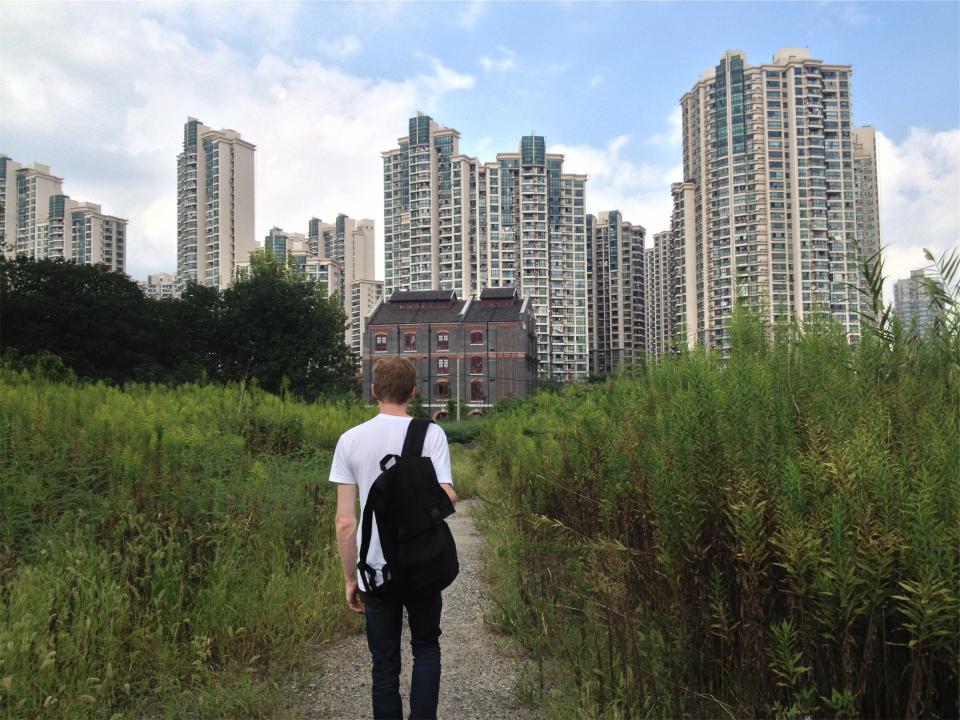 young walking urban tshirt Trail towers student path guy condos city buildings backpack apartments 