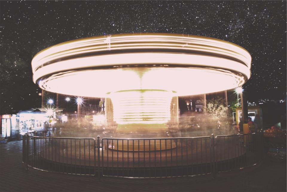 stars spinning ride railing night lights fun evening dark amusementpark 