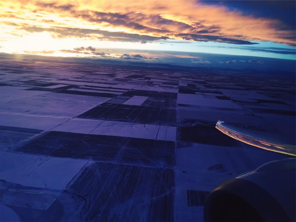 wing view sunset sky purple flying fields dusk clouds airplane aerial 