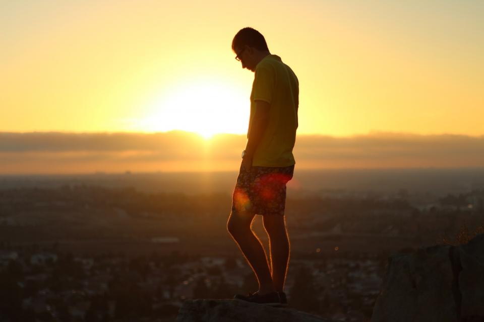 view sunset sky shorts shoes poloshirt people man guy dusk aerial 