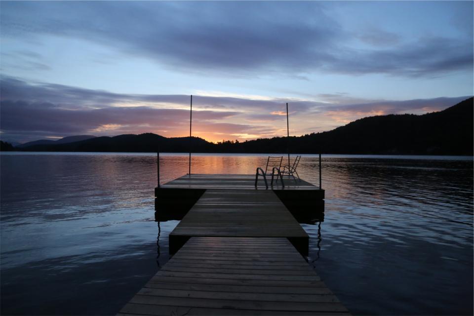 water sunset sky mountains lake dusk dock cottage clouds 